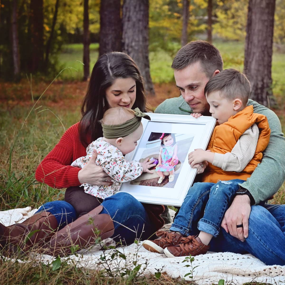 Jonathan and Shelby Skiles family holding photo of Sophie