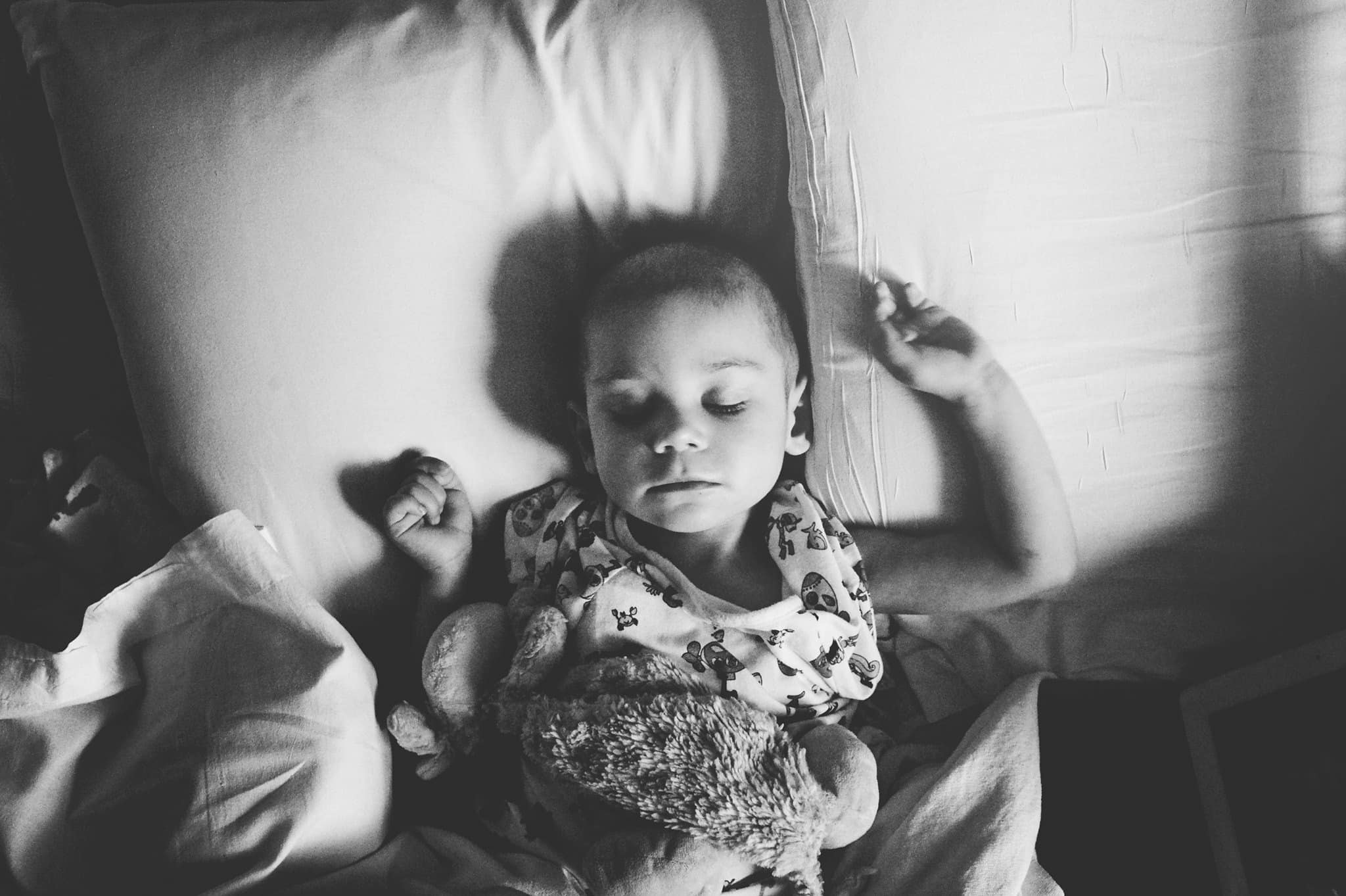 Baby with cancer sleeping in a hospital bed